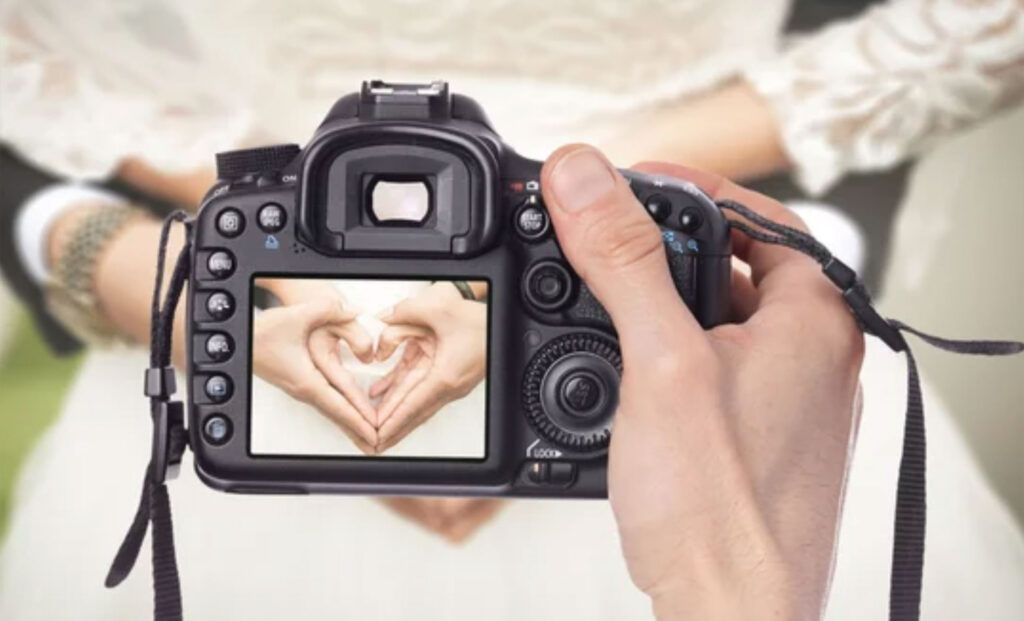 Professional Wedding Photographer taking pictures of bride and groom
