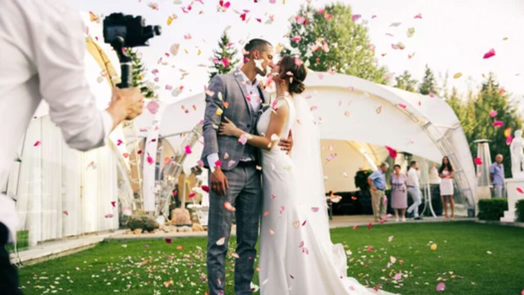 photographer shoots couple in rose petals
