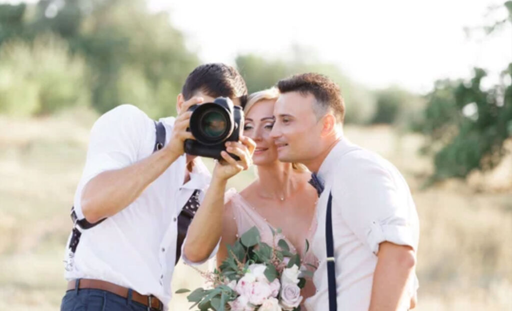 wedding photographer takes pictures of bride and groom
