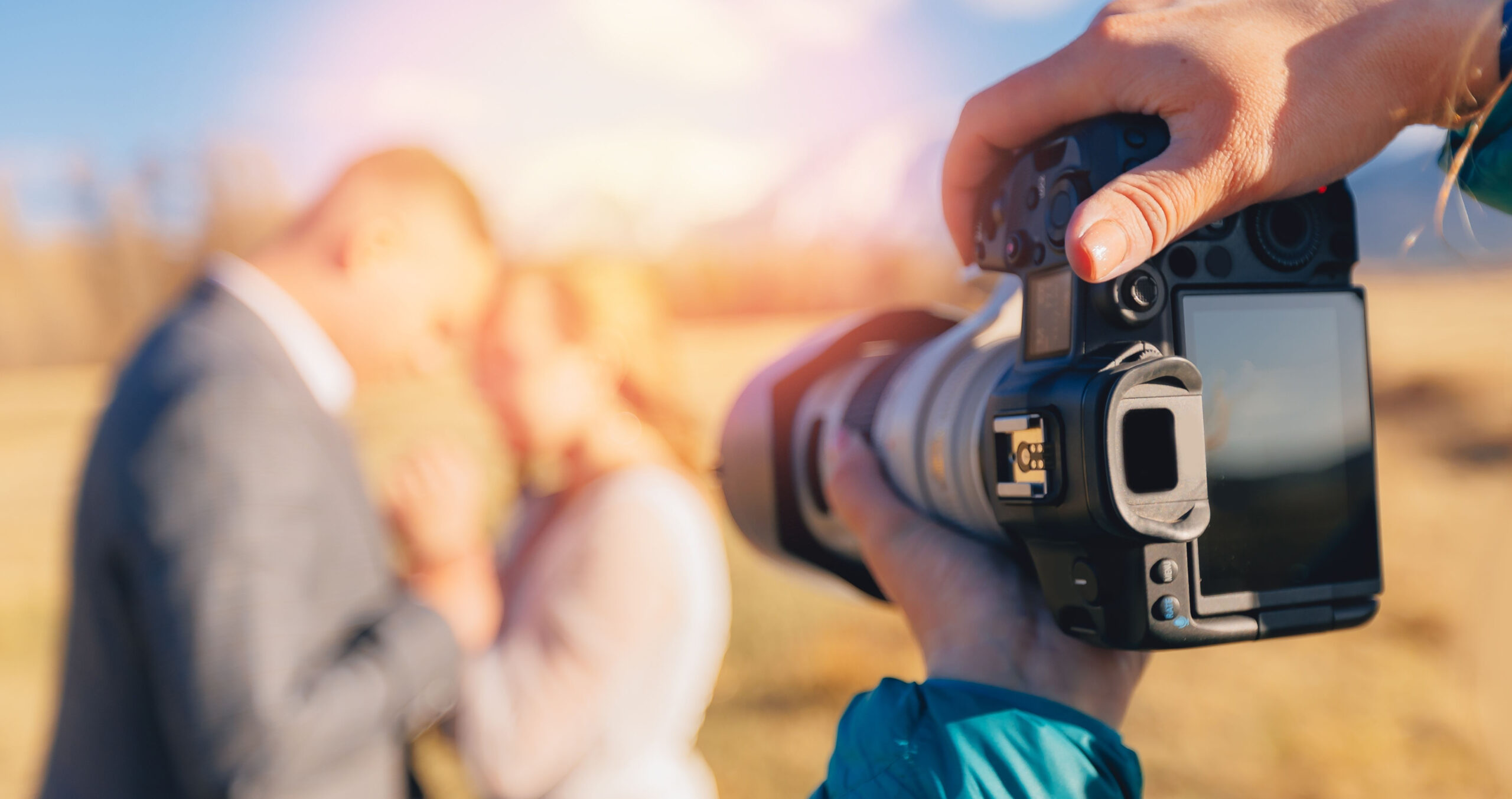 Selective focus camera of wedding photographer in action lover couple.