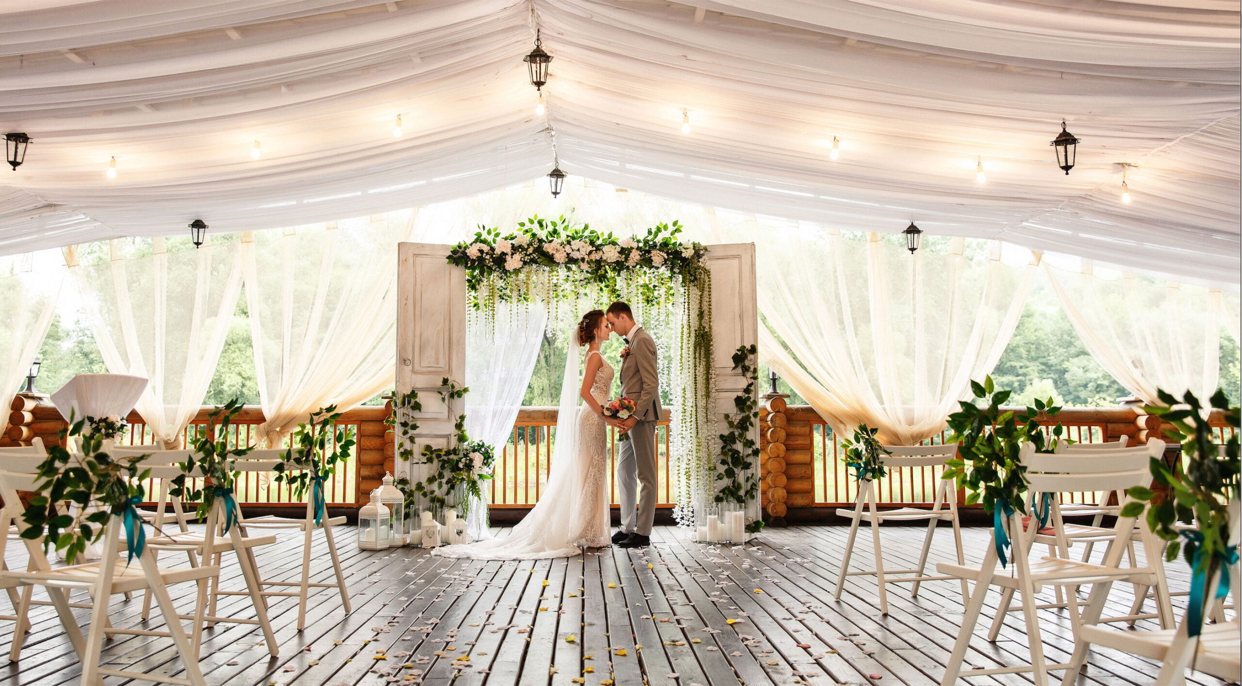 Wedding ceremony. Elegant wedding couple kissing near wedding arch, bride and groom in love