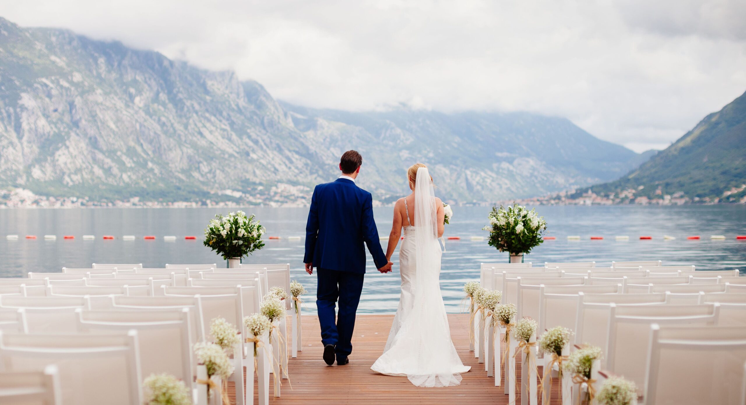 wedding couple at destination wedding ceremony. Mountains and sea view in Montenegro. Picturesque wedding location.